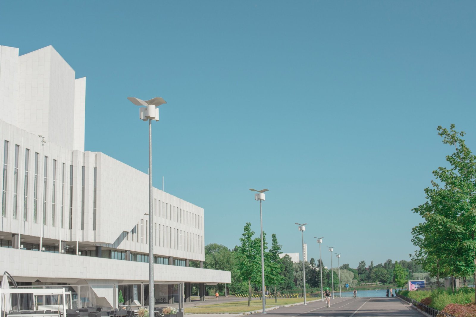 white street light near white concrete building during daytime